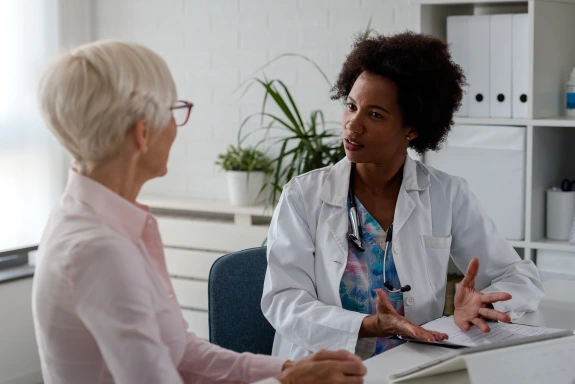 senior doctor speaking with senior patient
